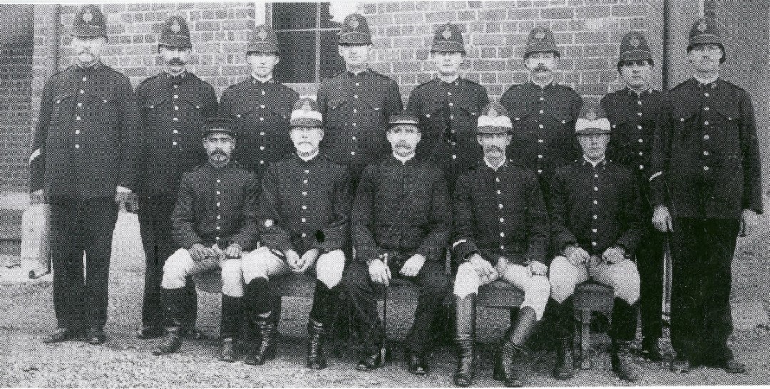 Group portrait of the officers stationed at the Dubbo police station in 1912. Alec Riley is seated at left in the front row. 