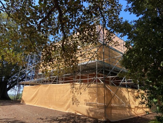 House covered with scaffold