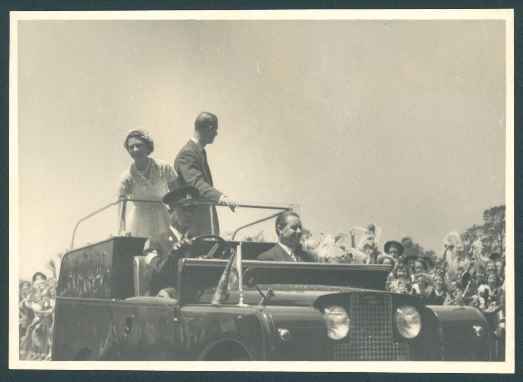 Queen Elizabeth II and the Duke of Edinburgh wave to children at the schools' gathering at Sydney Cricket Ground 1954