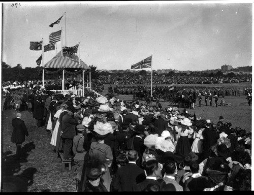 Spectators watch a military display on a field