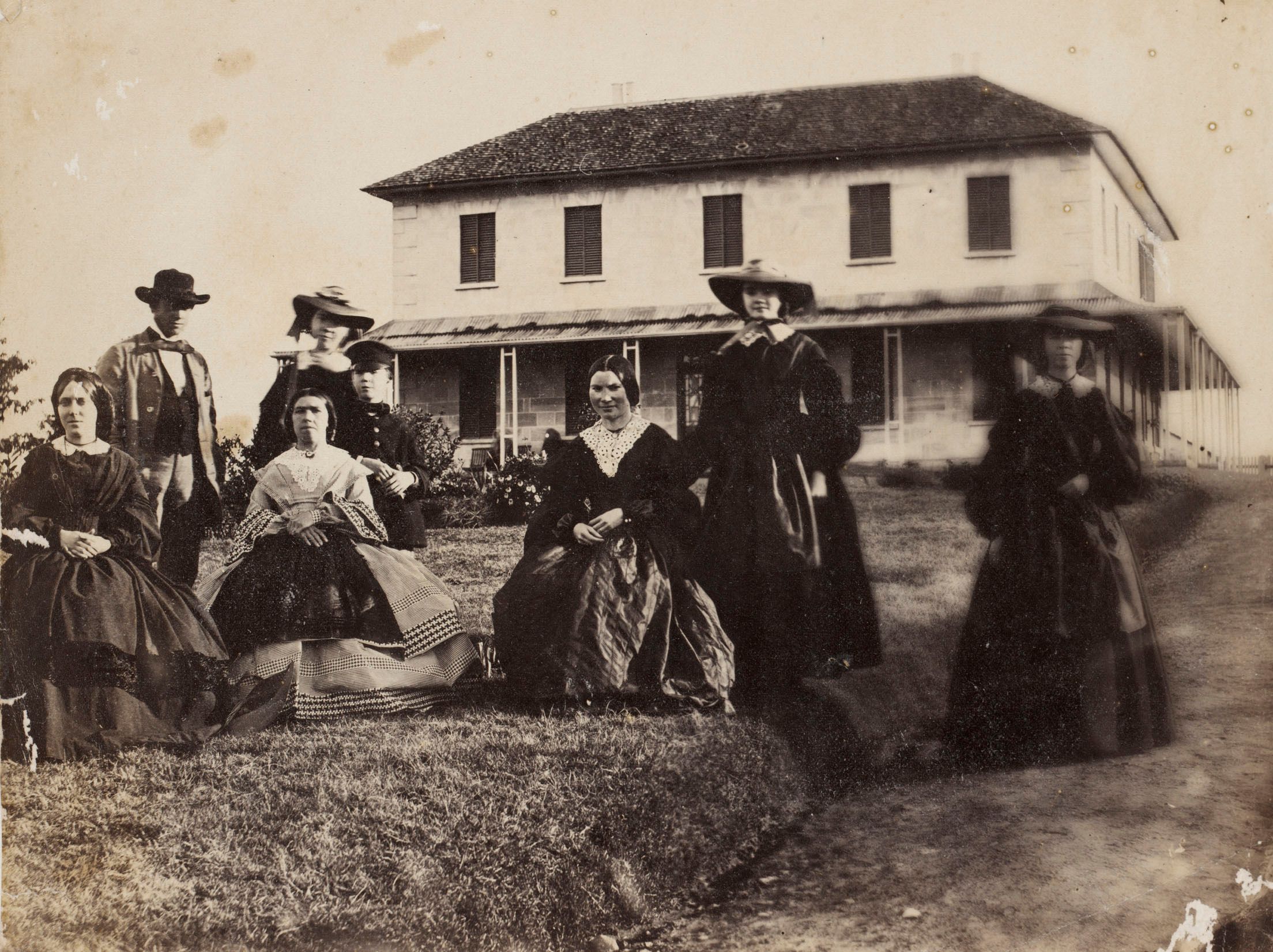 Black and white photo of family infront of a house