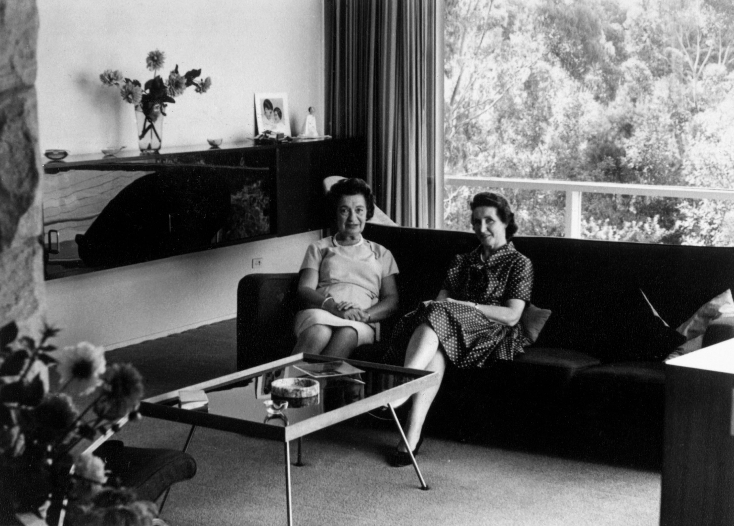 Black and white image of two woman sitting on a couch