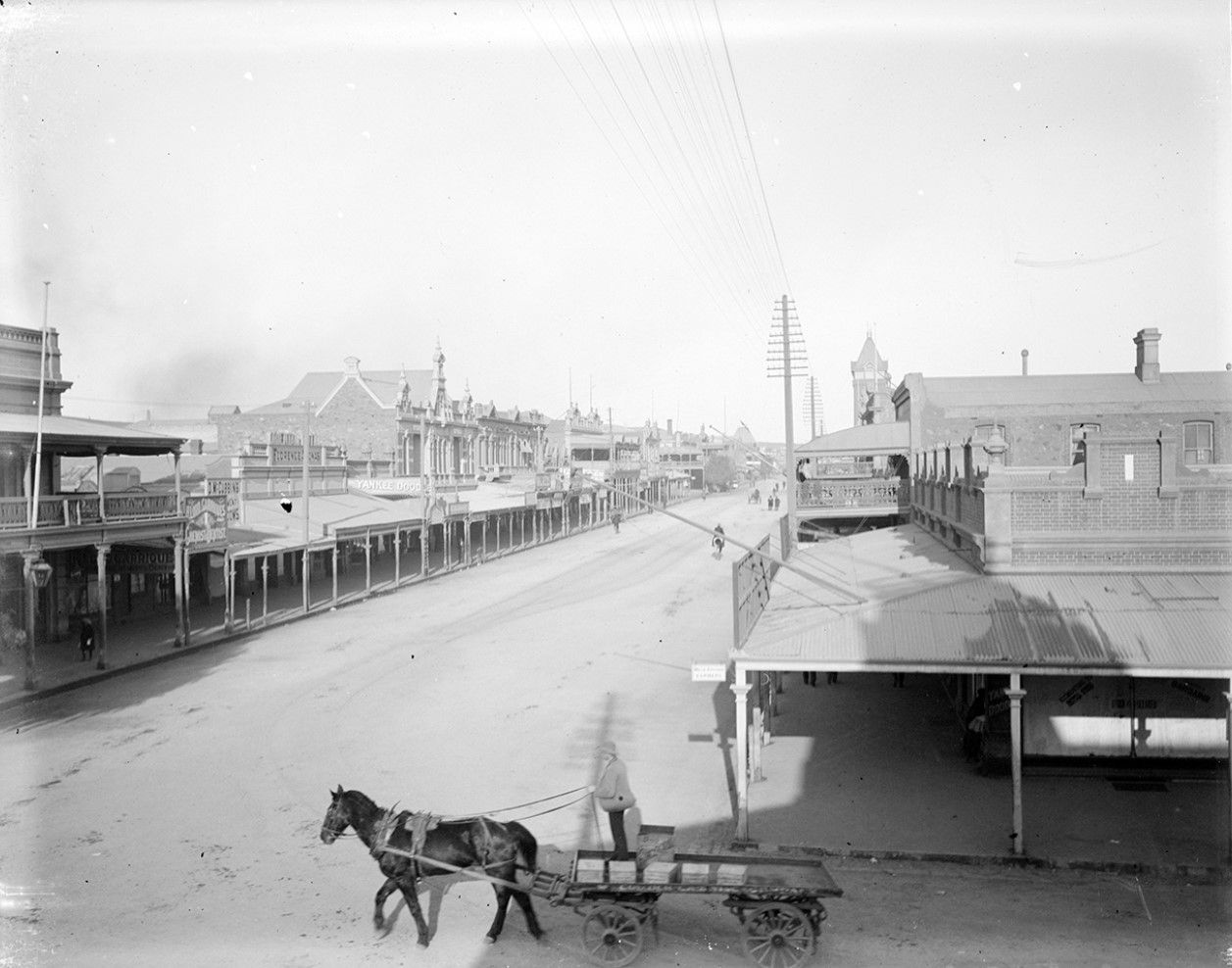 A horse and cart turn onto the main street
