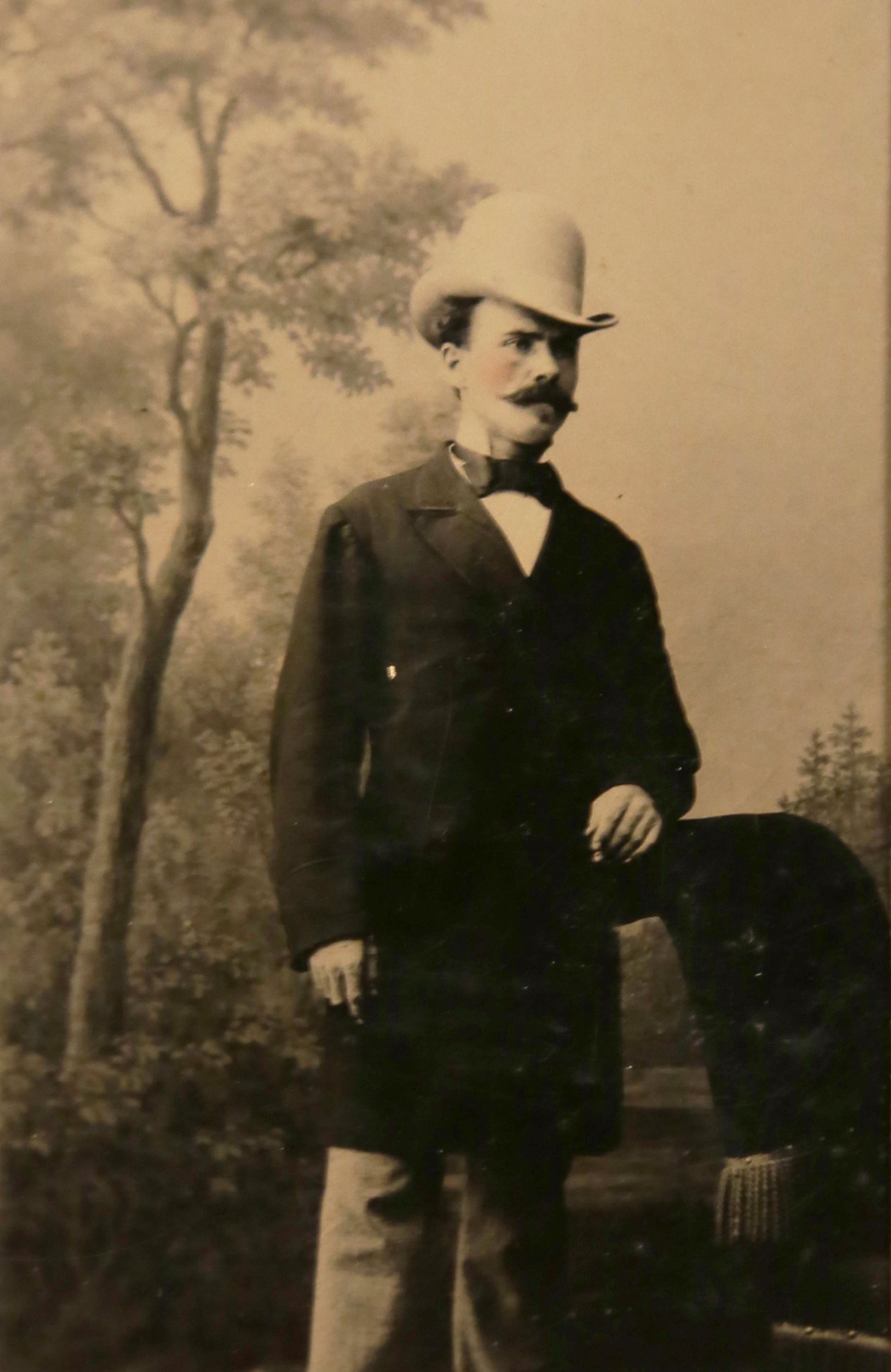 Studio portrait of a man standing in front of a nature background