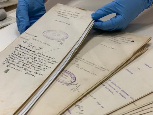 Gloved hands holding a divorce file