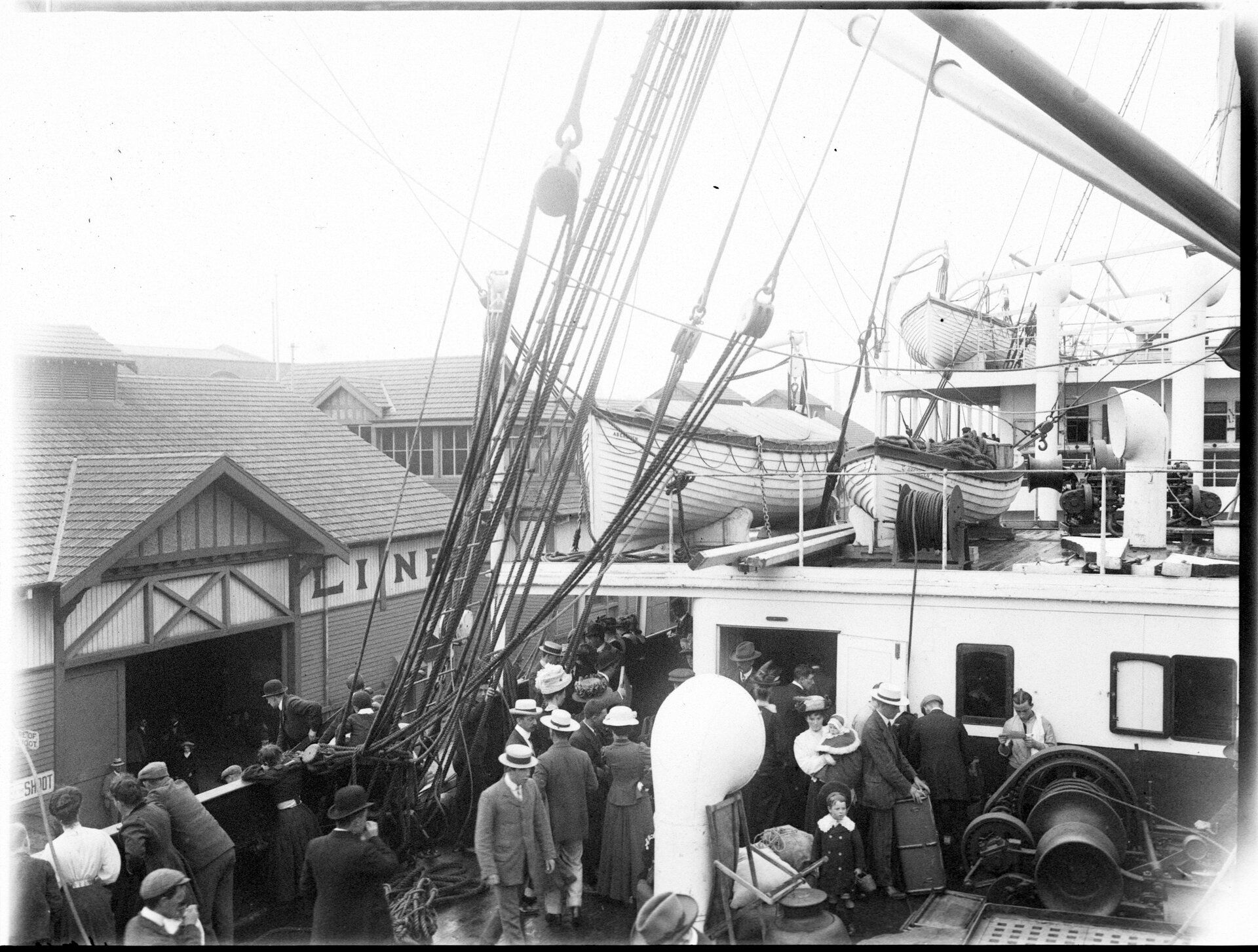 People crowd on board the deck of a ship