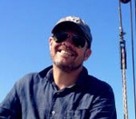 Man in blue shirt smiling