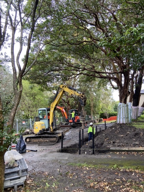 A crane moving material around a wet looking site