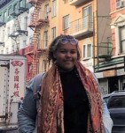 Photo of a woman wearing a colourful scarf in a busy street