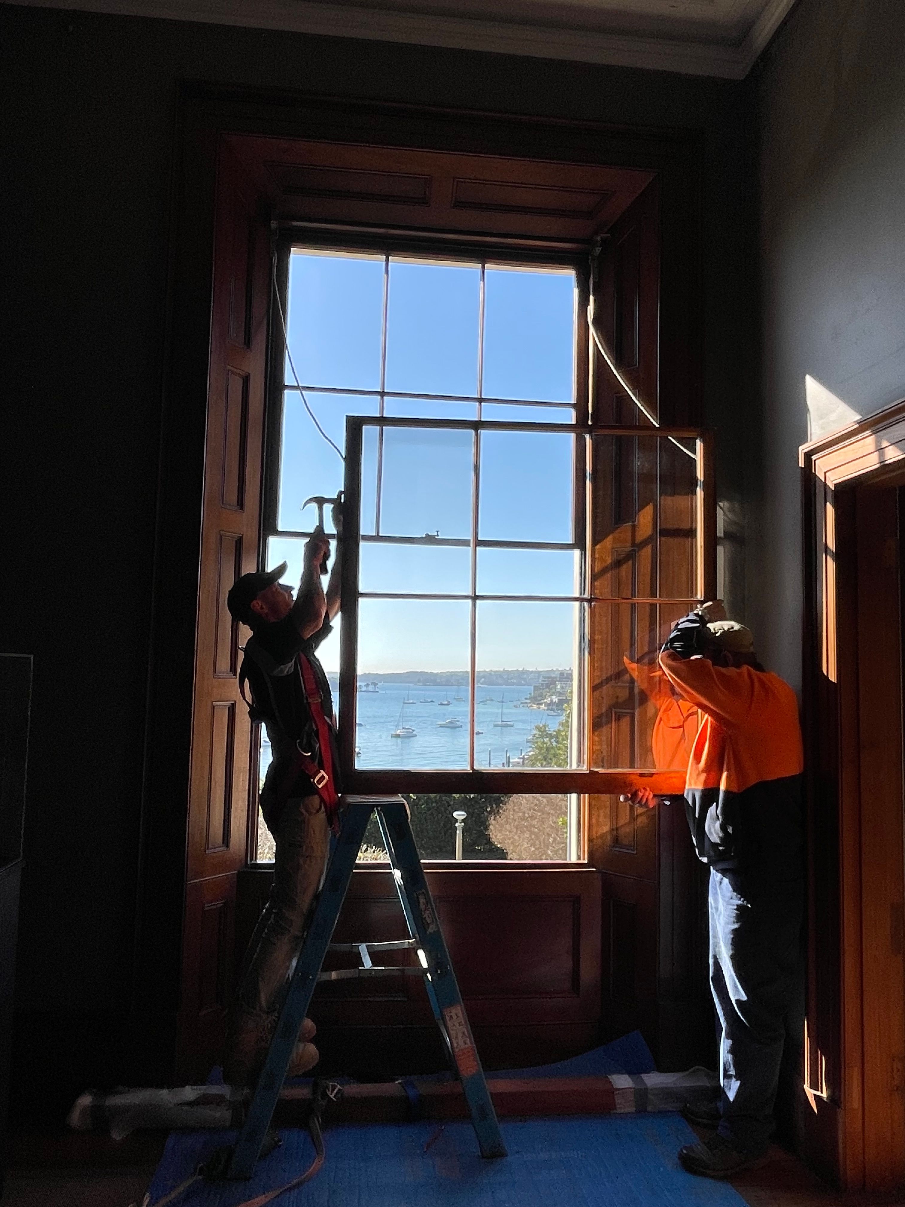 Conservation joiner nailing sash cords onto bottom sash in preparation for installation