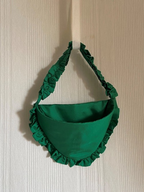 Green silk watch pocket with ruffle edging