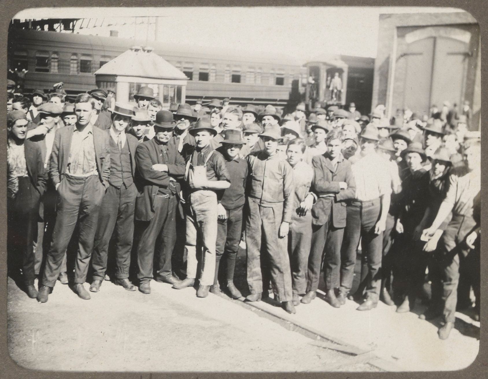 A large group of men stand in front of a train carriage at the Eveleigh Workshops in 1917