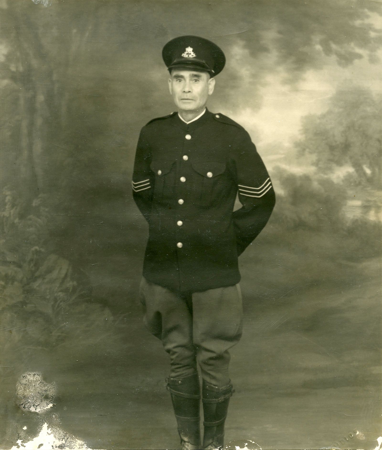 Sergeant Tracker Alexander ‘Alec’ Riley, standing in police uniform