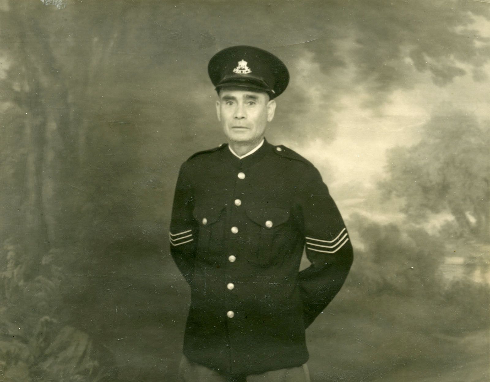 Sergeant Tracker Alexander ‘Alec’ Riley, standing in police uniform