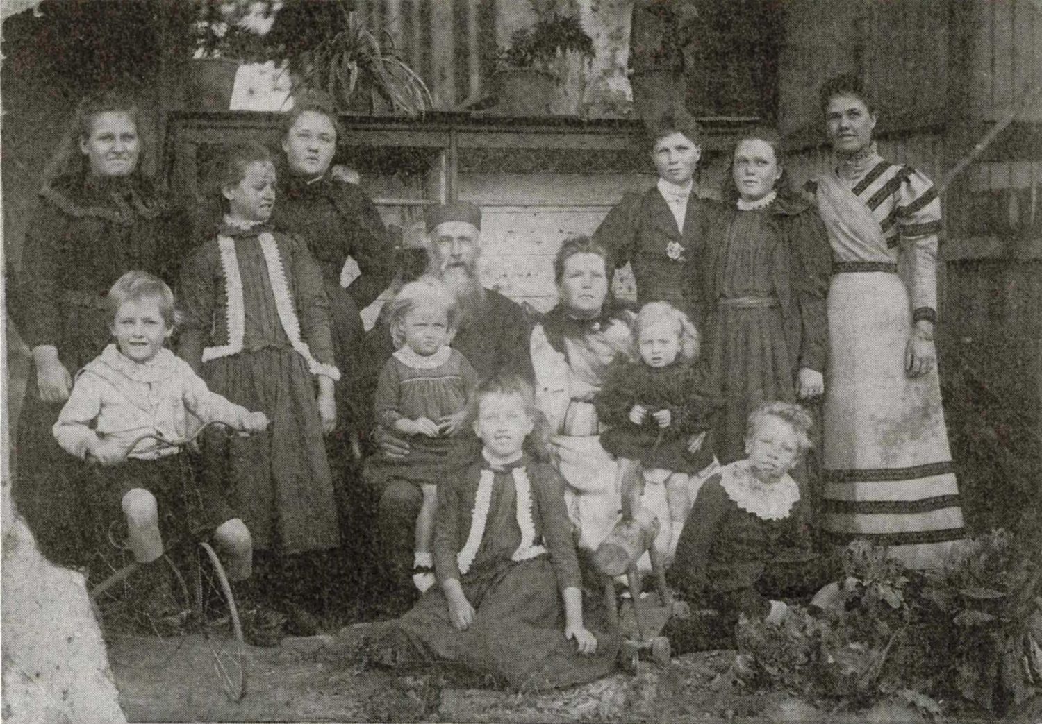Black and white image of a group of men, women and children.