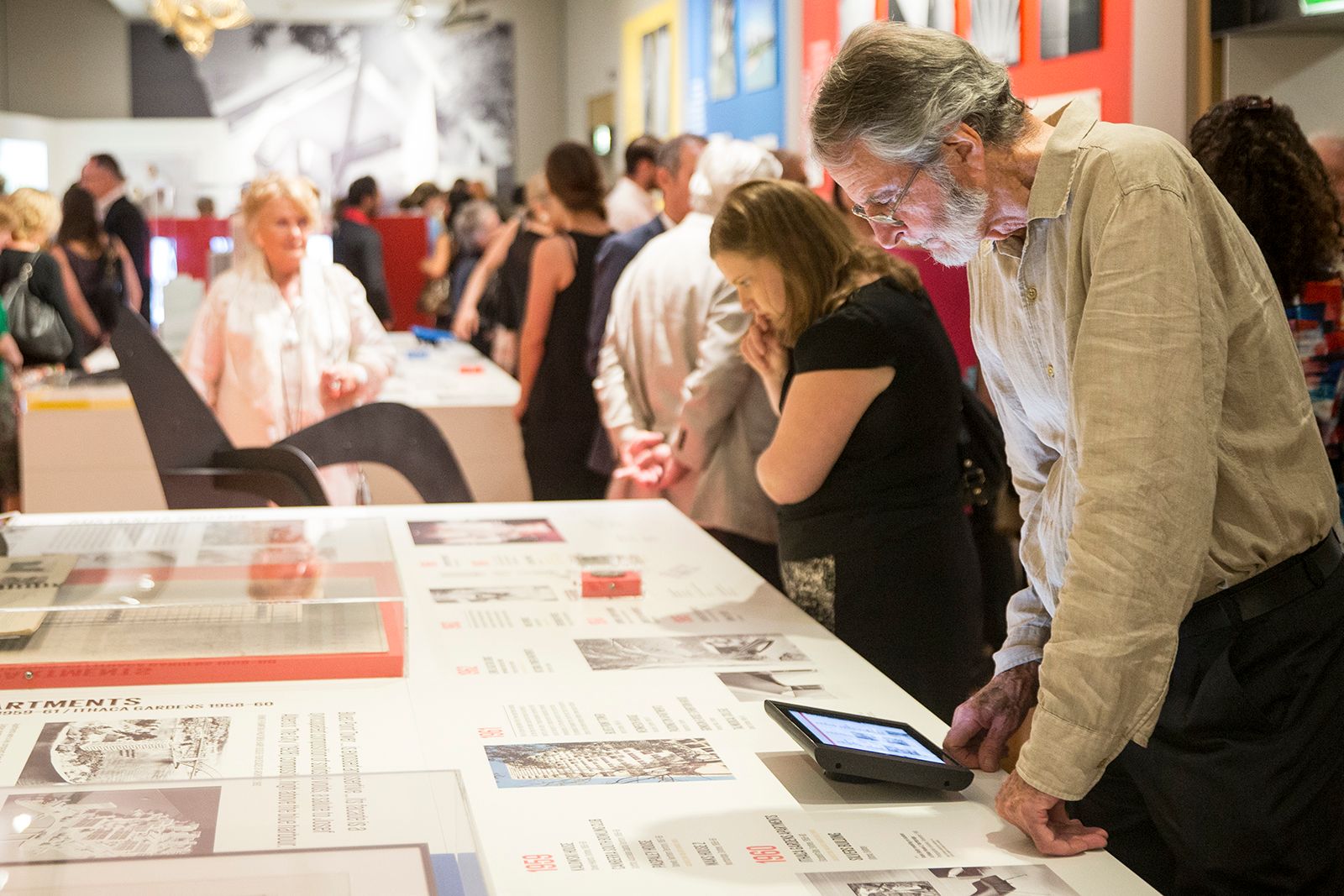 Museum visitors browse a display