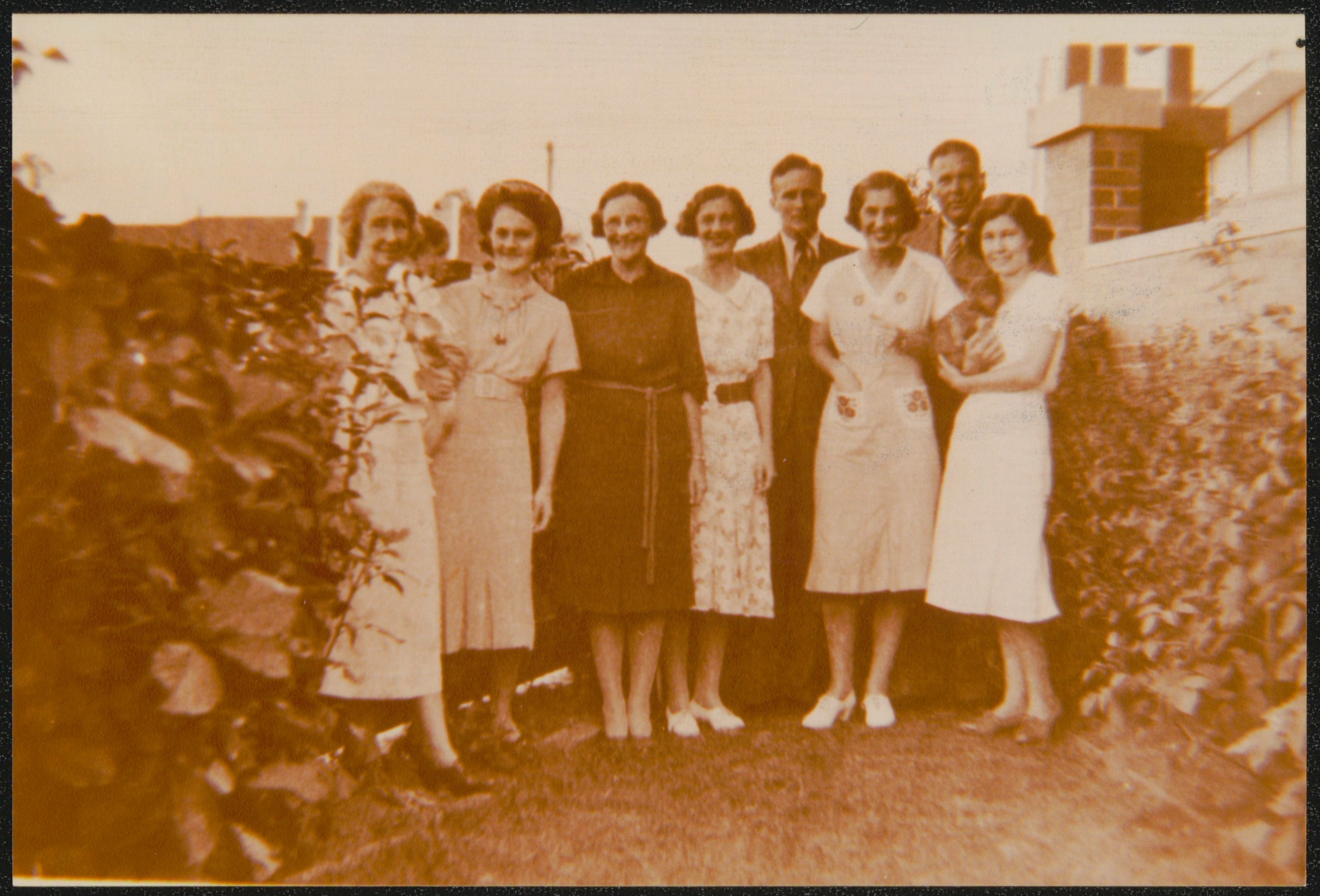 A group of men and women pose for the camera 