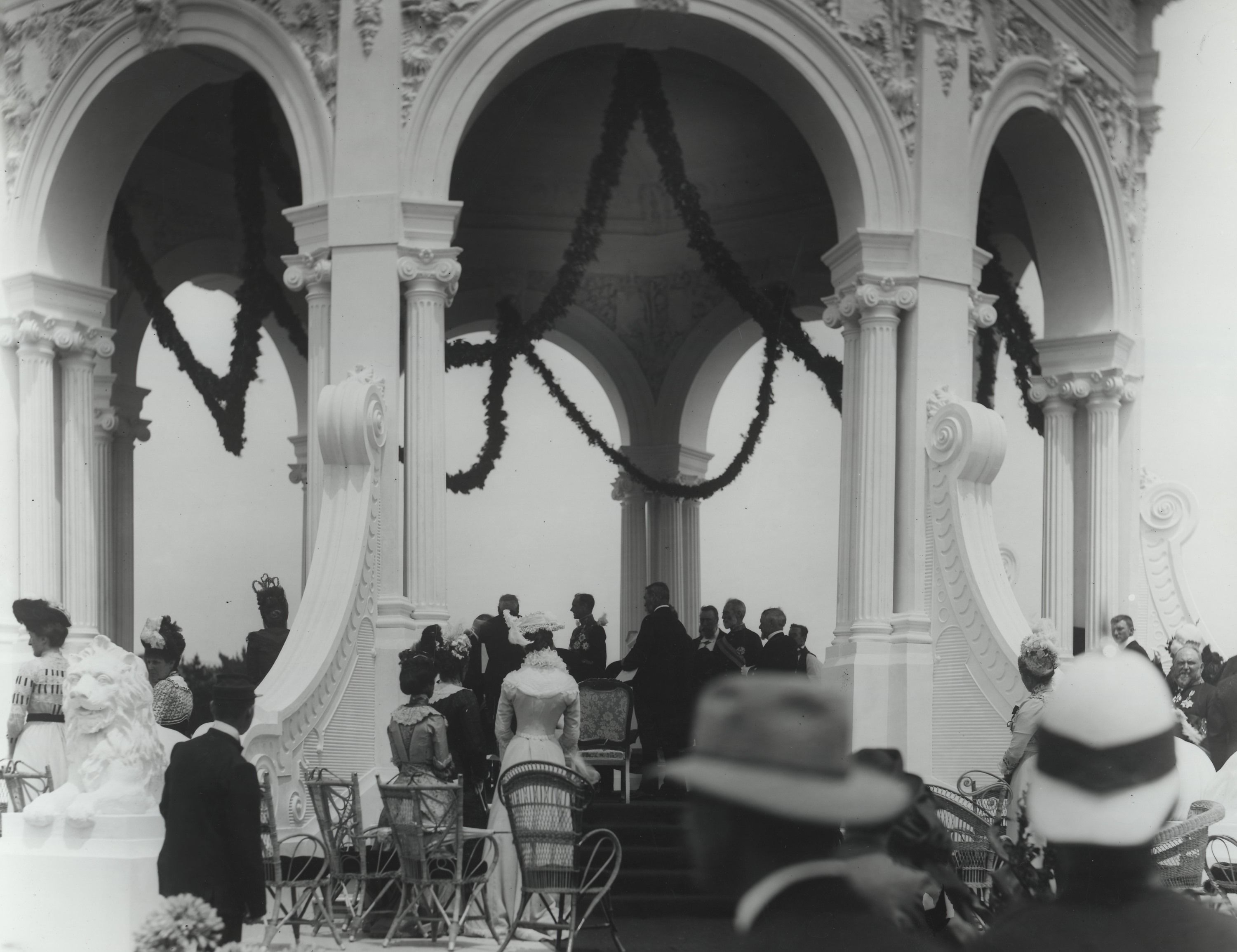 A crowd of people in a rotunda decorated with streamers
