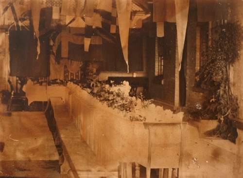 Black and white image of a long table set for a special event