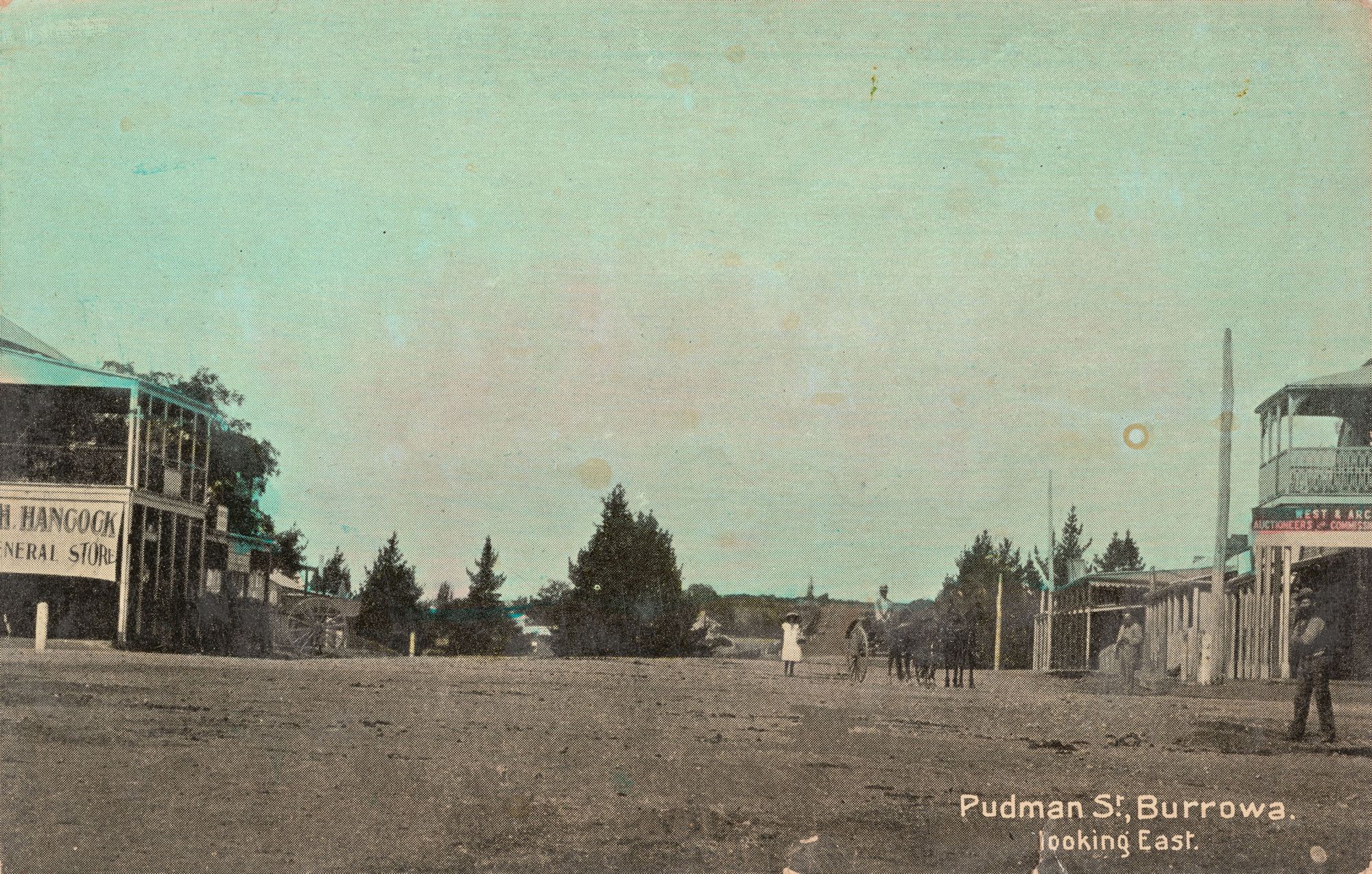 Postcard design with photograph of street in Burrowa with houses and shops