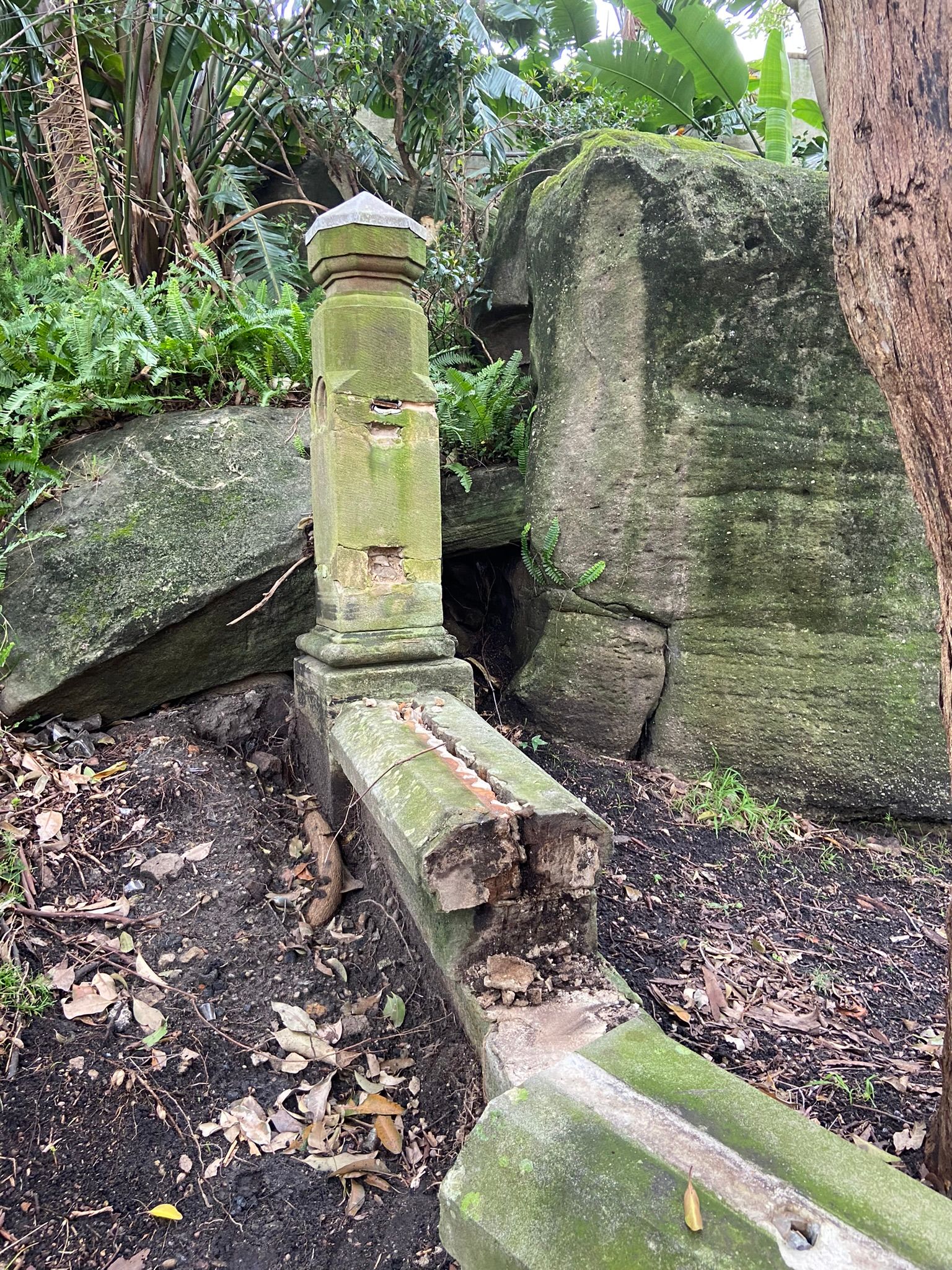 Badly damaged sandstone with green moss
