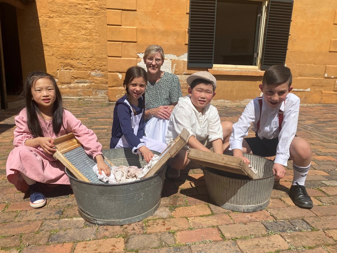 Teacher and students participating in a learning program at Elizabeth Farm