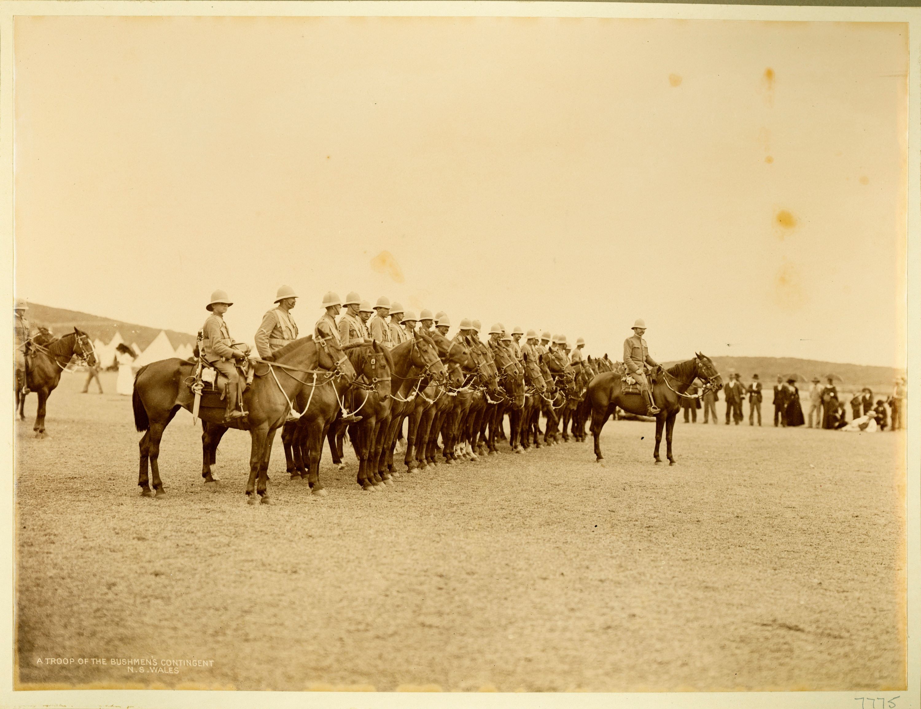 A row of mounted troops lined lined up behind behind their commander