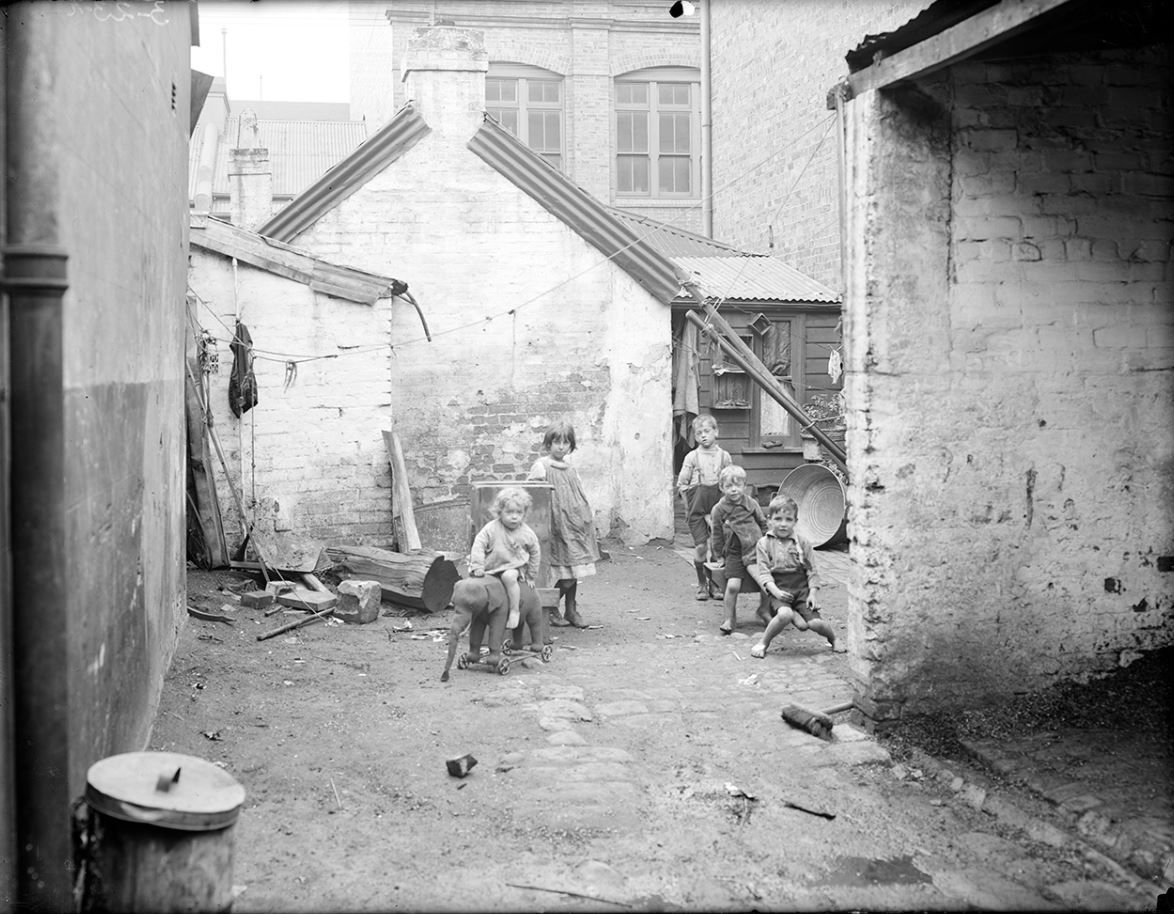 Mr Bradfield's Houses - Department of Public Works, image of children playing outside with see saw and ride on elephant