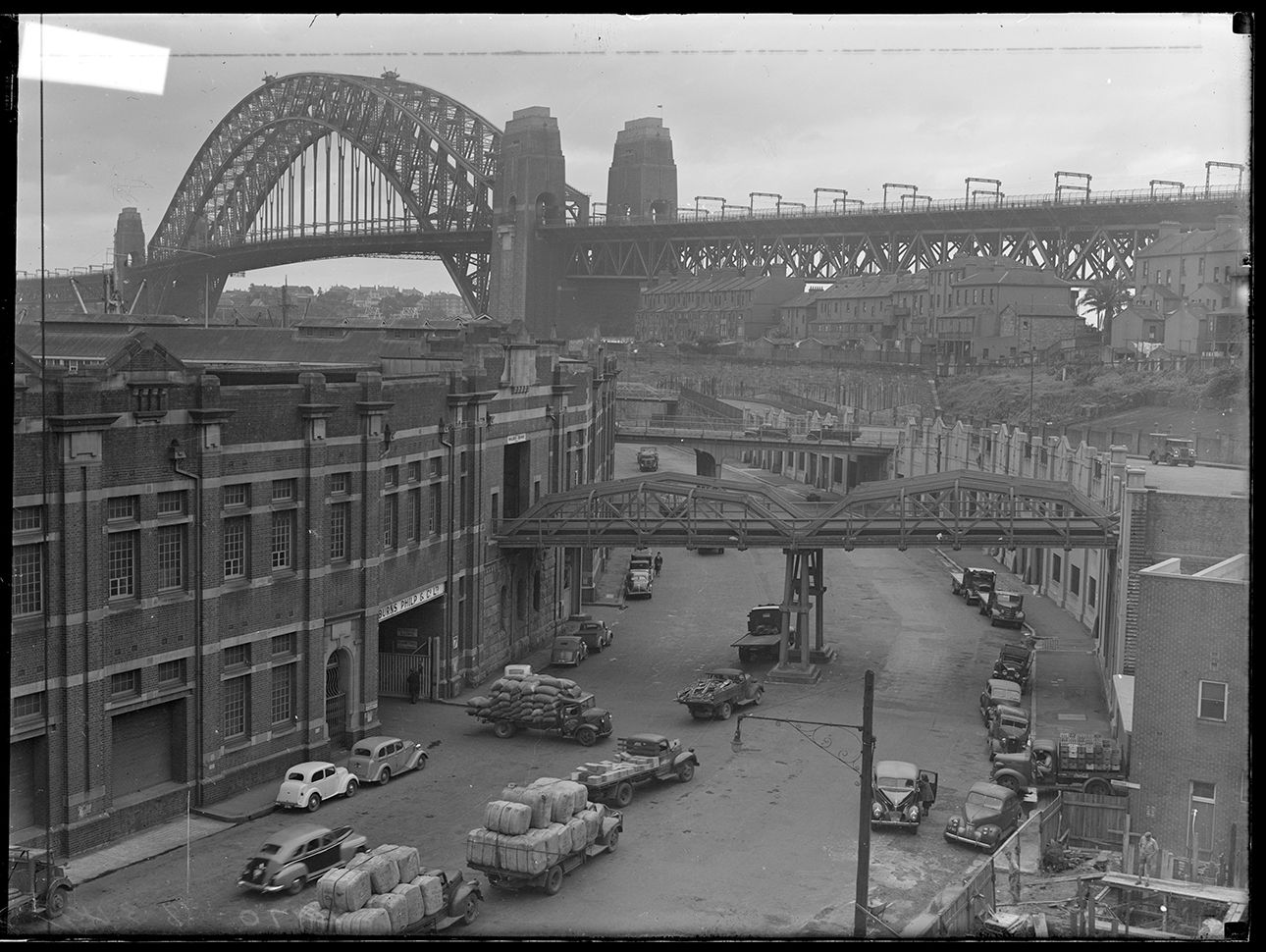 1949 Commercial scene with Sydney Harbour Bridge in the background
