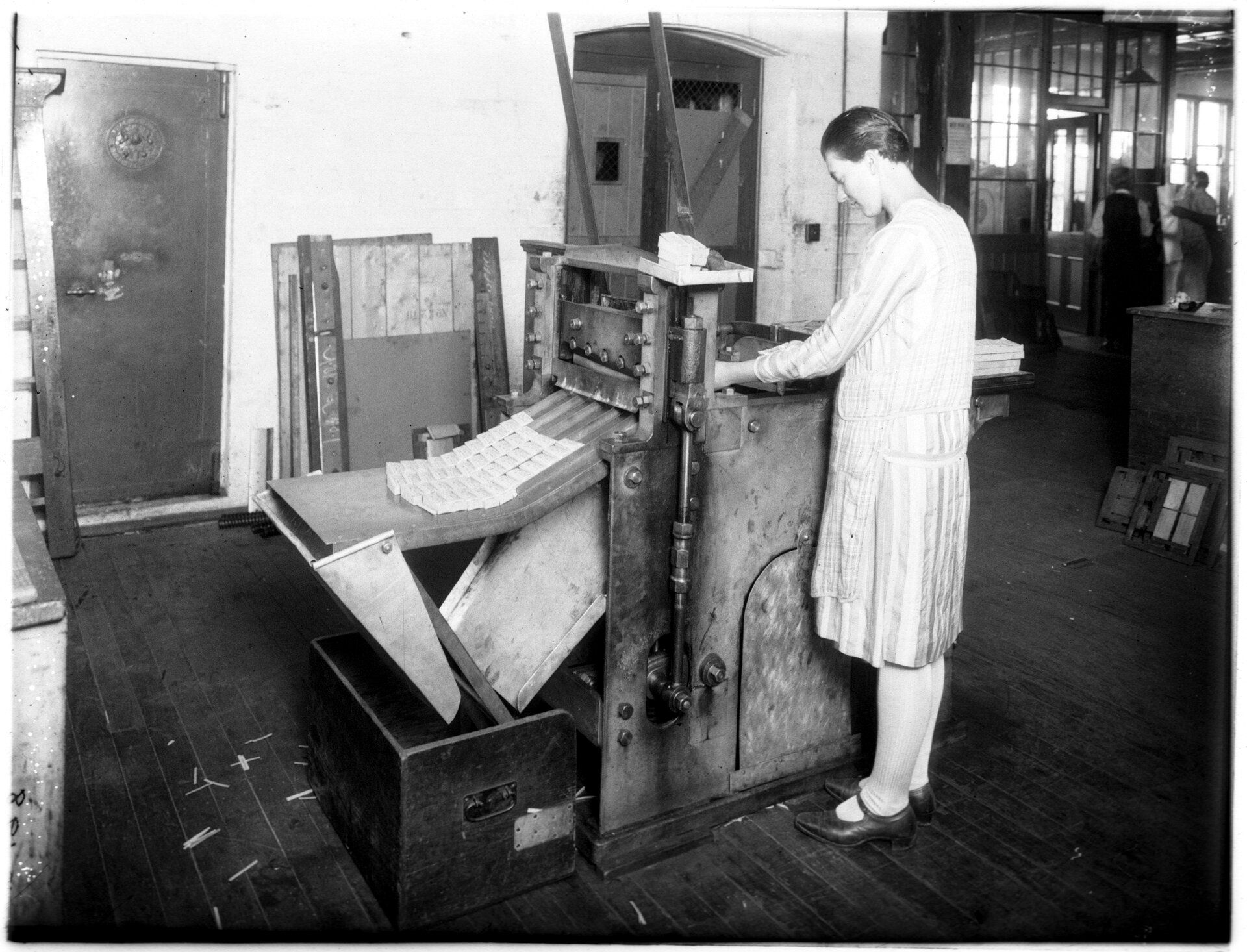 A woman working a machine in a workshop