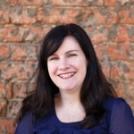 Photograph of a woman with dark hair smiling.