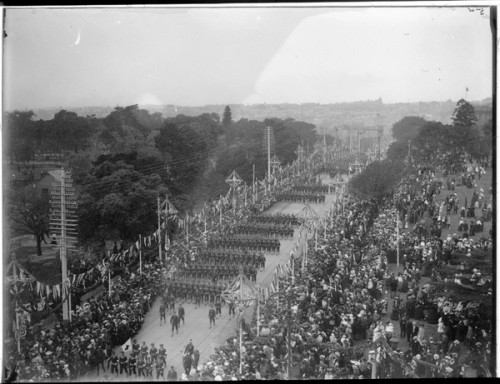  A military parade is watched by crowds of spectators