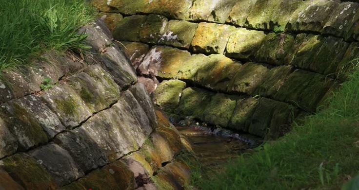 A creek with stonework banks