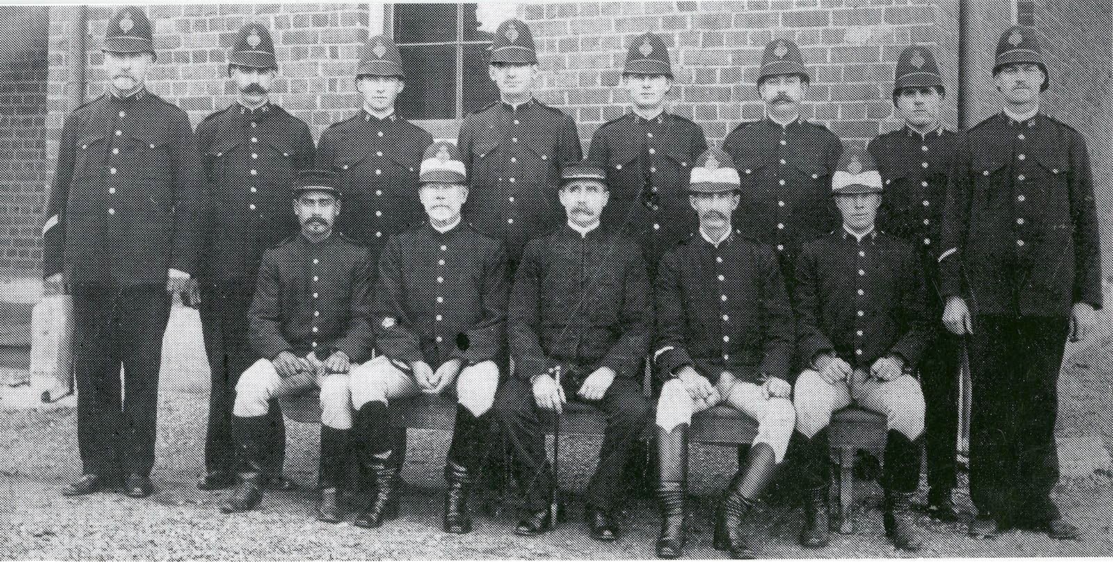 Group portrait of the officers stationed at the Dubbo police station in 1912. Alec Riley is seated at left in the front row. 
