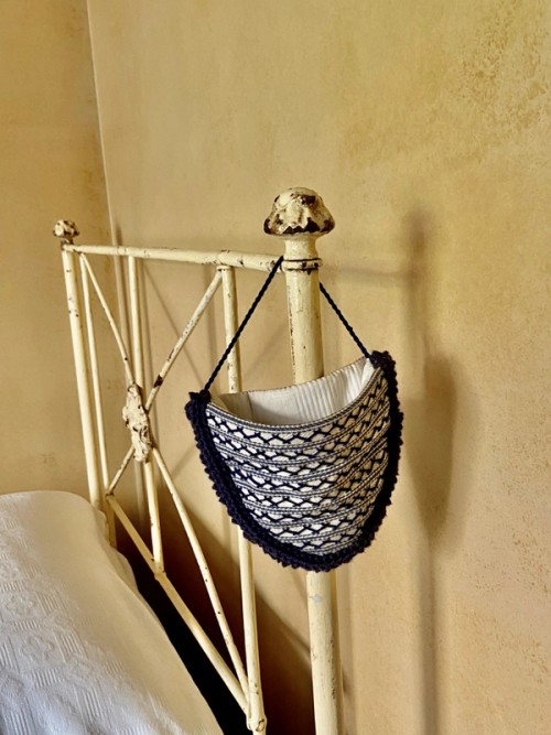 Watch pocket hanging from a bed frame