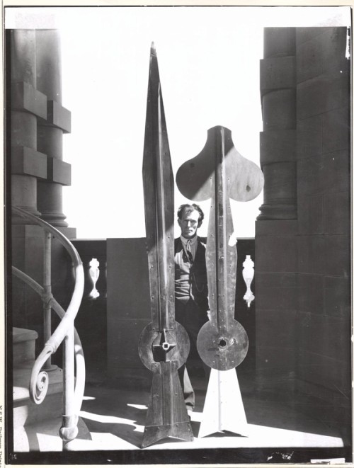 man holding clock hands taller than himself