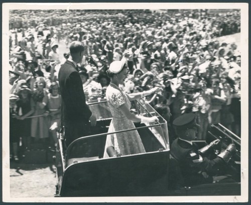 Queen Elizabeth II and the Duke of Edinburgh wave to children at the schools' gathering at Sydney Cricket Ground 1954