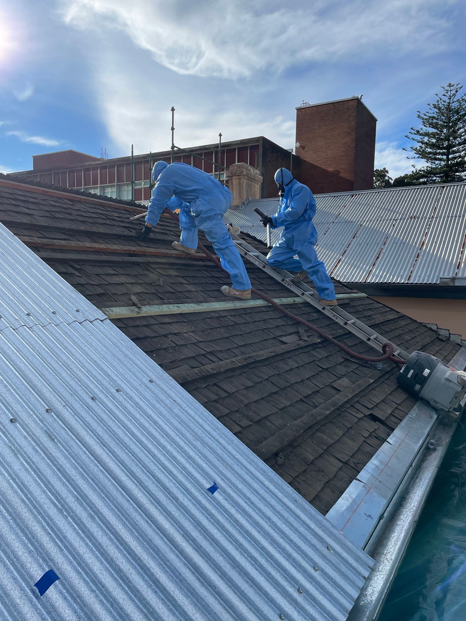 Cleaning of old timber shingles prior to roof sheet installation