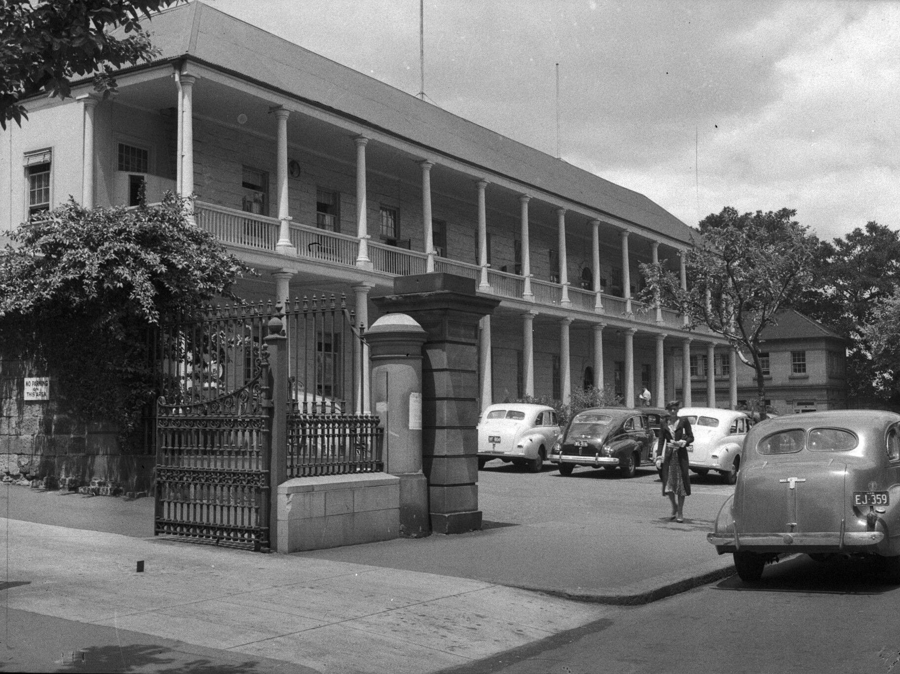 The Mint building with cars parked in the foreground