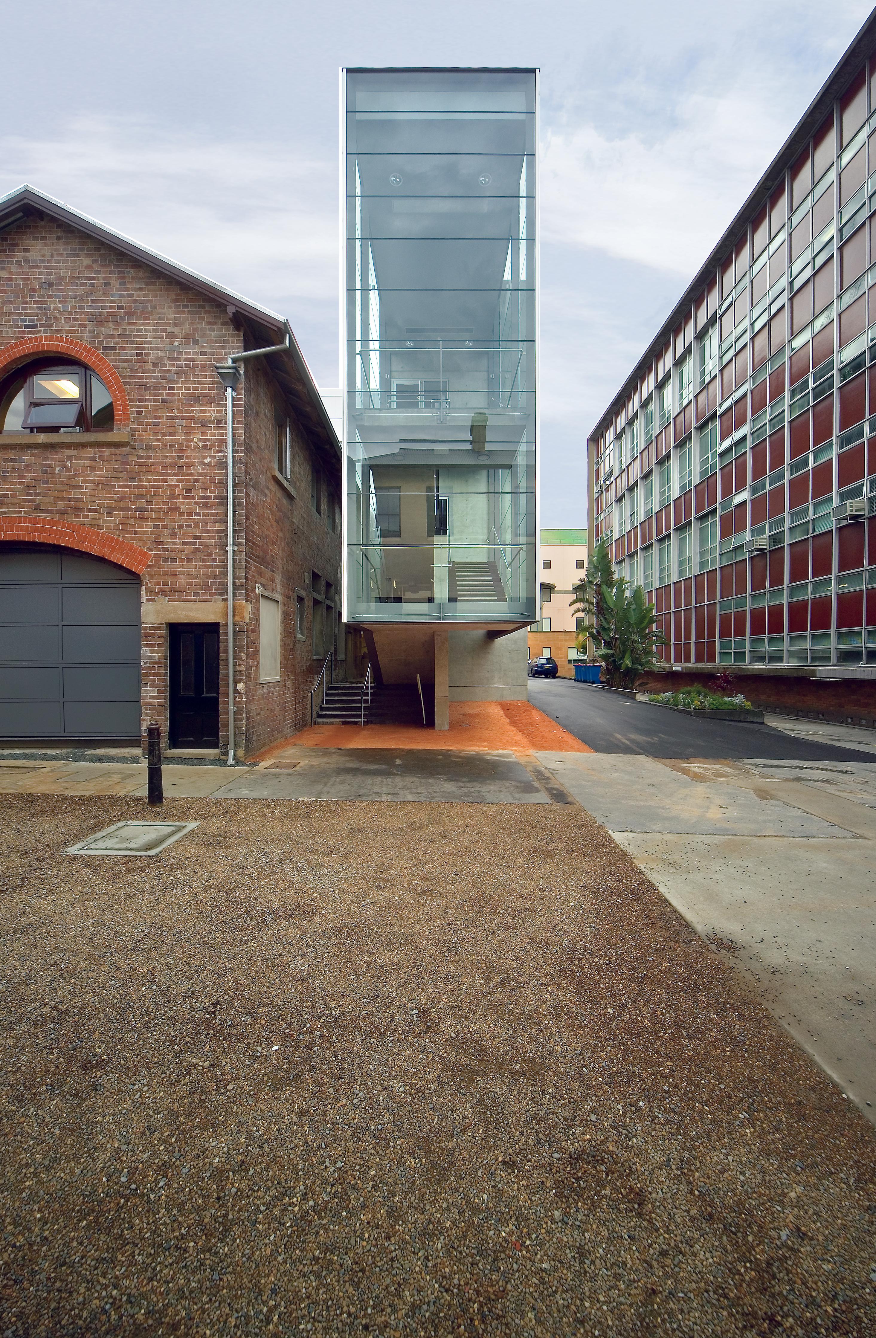 The glazed eastern staircase of the new three-storey office building at the rear of the site. The Hospital Road law courts building (1952) on the right