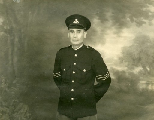 Sergeant Tracker Alexander ‘Alec’ Riley, standing in police uniform