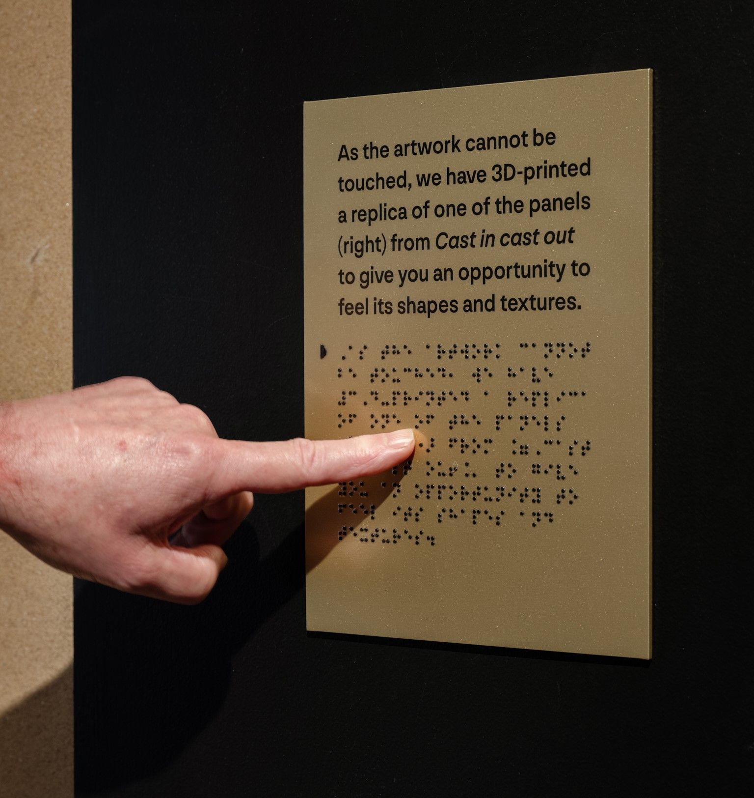 Tactile sign including translation in Braille, facilitated by staff from Vision Australia