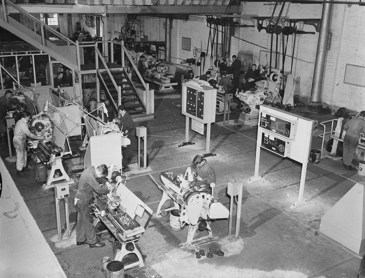 Mechanics at various workbenches in a workshop