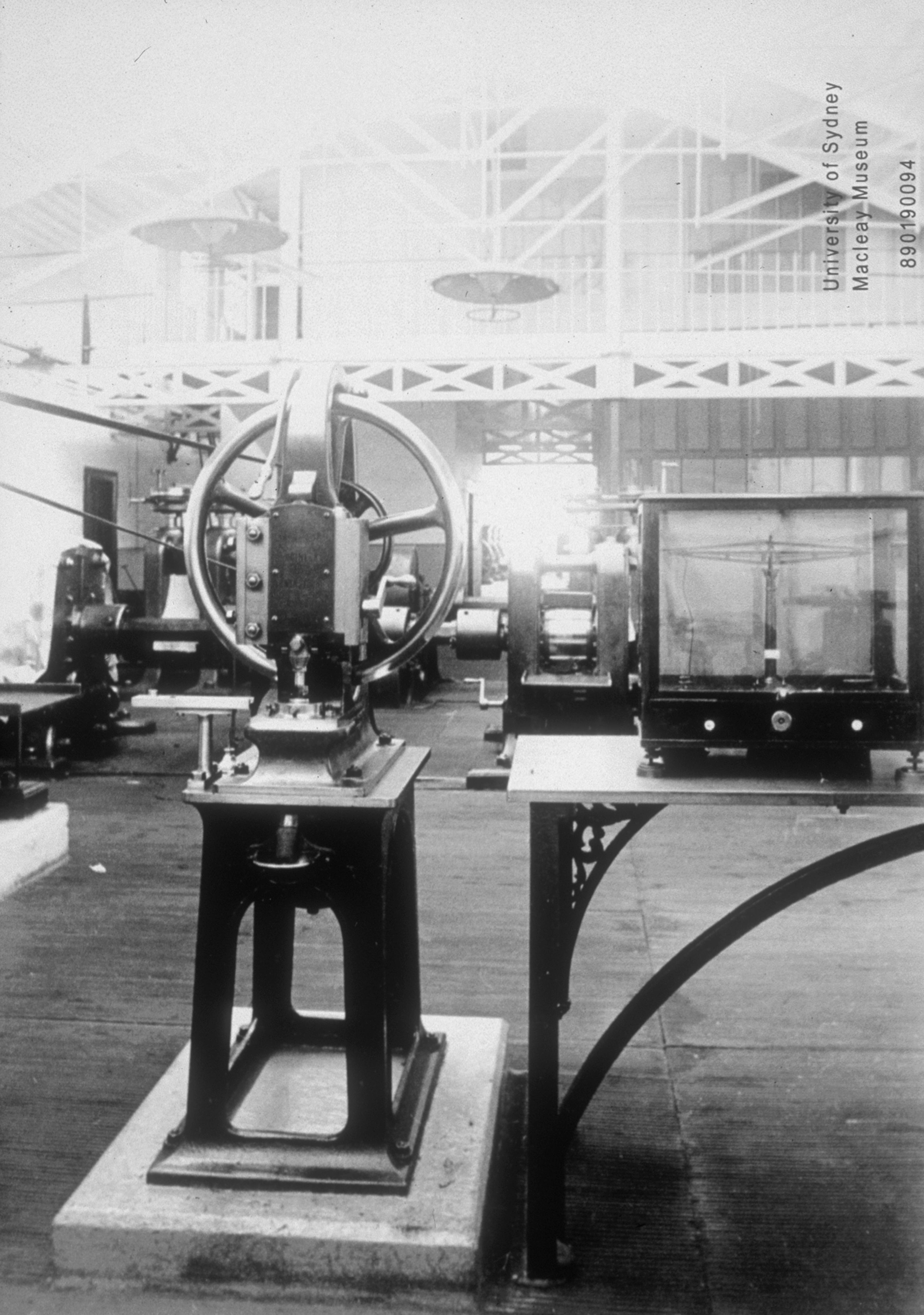 The rolling room in 1892, looking towards the superintendent’s office. From the upper level the superintendent could observe operations in both this room and the adjacent coining room. Two suspended gaslight fittings are visible