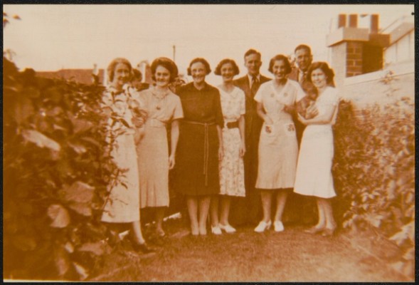 A group of men and women pose for the camera 