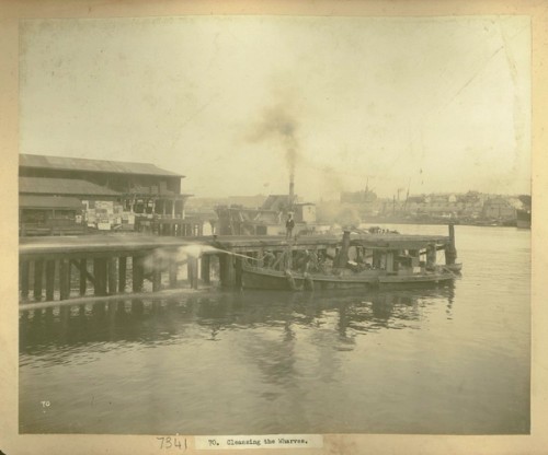 Men cleansing the wharves from a punt 
