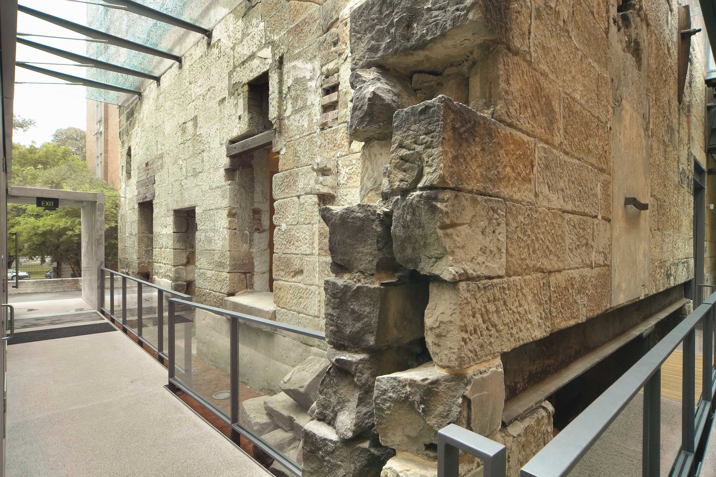 Exterior of the engine room at the Mint at the completion of the adaptive reuse project, the wall stabilised and now protected by the new structure