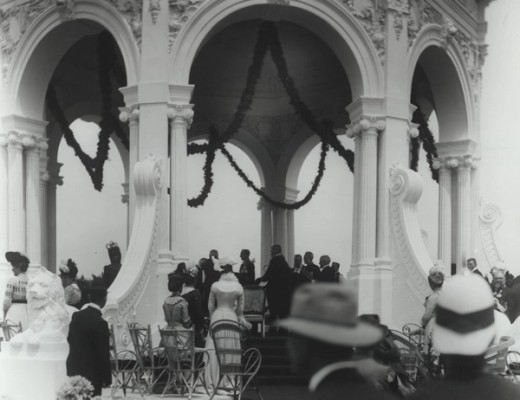 A crowd of people in a rotunda decorated with streamers
