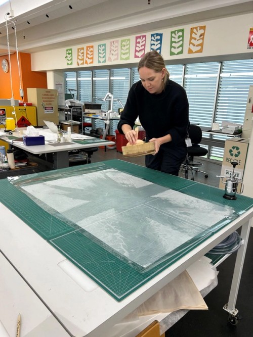  We used diluted wheat starch paste as the adhesive to attach the lining. Here, Abby is brushing the paste onto Japanese tissue paper. We chose this paper as it is lightweight but strong and flexible