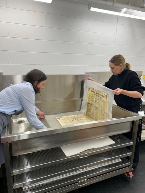  After about an hour, the item was carefully removed from the sink by lifting the supporting sheet of Hollytex (a non-woven fabric) and then placed face down onto the wet area bench in readiness for lining. The new sink is mobile and can be moved out to allow staff to access the sides